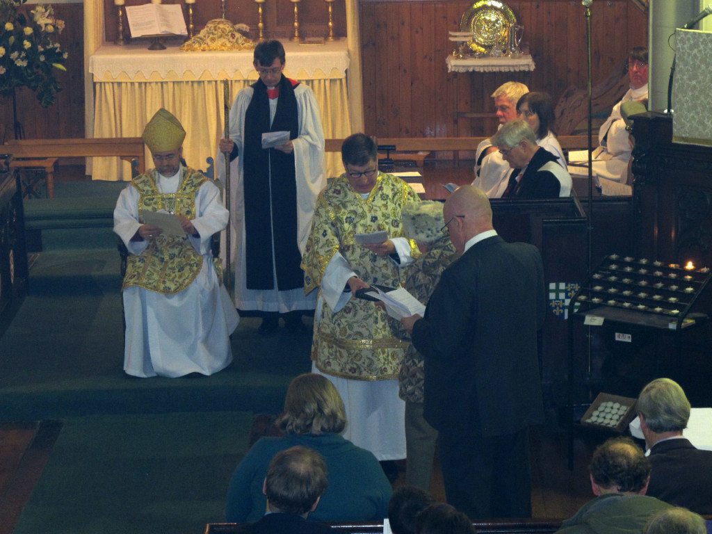 Canon Allan Maclean is presented with a Bible by Anne Clutterbuck and Holy Oils by Barnaby Miln at his Institution on St Vincent's Day, 22 January 2015