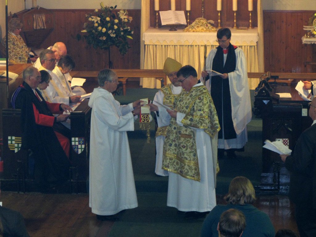 The Sacristan, Christopher Hartley, presents a stole to Canon Allan Maclean at his Institution to St Vincent's on St Vincent's Day, 22 January 2015