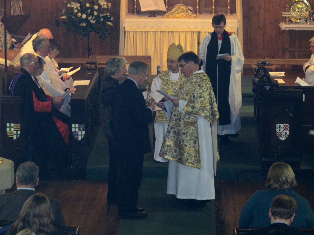 Patricia and Dermot Quinn present the communion vessels to Canon Allan Maclean during his Institution Eucharist as Rector of St Vincent's on St Vincent's Day, 22 January 2015